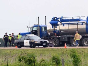 Ontario Provincial Police remain on the scene of a tanker truck accident on Highway 401 in Chatham-Kent on June 25, 2013.  The westbound lanes of the highway were closed for several hours while emergency crews cleaned up the scene.  (JASON KRYK/The Windsor Star)