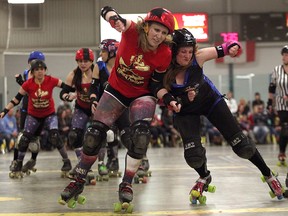 Border City Brawler Christine Shaw, right, collides with Pixie Kix of the London FC Timber Rollers during a match at Forest Glade Arena. (THE WINDSOR STAR/ Kristie Pearce)