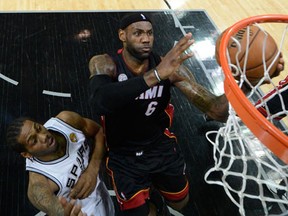 Miami's LeBron James, right, takes a shot against Kawhi Leonard of the San Antonio Spurs in Game 4. (Photo by Derick E. Hingle/Pool/Getty Images)