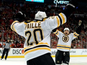 Boston's Daniel Paille, left, celebrates with  Andrew Ference after Paille scored the game-winning goal in the first overtime against the Chicago Blackhawks Saturday at United Center in Chicago. (Photo by Harry How/Getty Images)