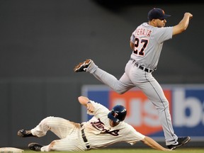 Minnesota's Clete Thomas, left, is out at second base as Jhonny Peralta of the Tigers turns a double play during the eighth inning Saturday at Target Field in Minneapolis. (Photo by Hannah Foslien/Getty Images)