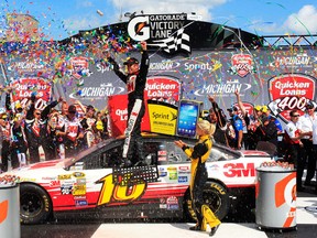 Greg Biffle, driver of the #16 3M/Give Kids a Smile Ford, celebrates in Victory Lane after winning the NASCAR Sprint Cup Series Quicken Loans 400 at Michigan International Speedway Saturday  in Brooklyn, Michigan.  (Photo by Geoff Burke/Getty Images)