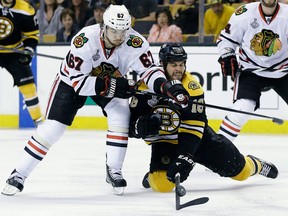 Chicago's Michael Frolik, left, checks Boston's Nathan Horton during the second period in Game 3 of the Stanley Cup final in Boston Monday. (AP Photo/Elise Amendola)