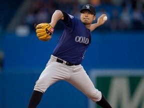 Colorado pitcher Jorge De La Rosa throws a pitch against the Toronto Blue Jays in Toronto Monday. (THE CANADIAN PRESS/Frank Gunn)