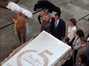 Caesars Windsor CEO Kevin Laforet, centre, is joined by Nadia Hamdon, left, and Emma Truswell, and other dignitaries around a huge cake at 5th anniversary party Tuesday June 11, 2013. (NICK BRANCACCIO/The Windsor Star)