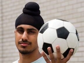 Aneel Samra, 18, holds a soccer ball in his backyard Wednesday, June 5, 2013 in Montreal. Samra has not been able to play organized soccer since last year due to his religious headgear.THE CANADIAN PRESS/Ryan Remiorz