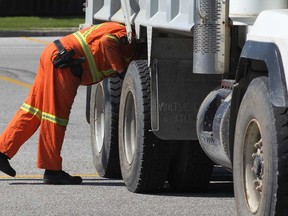 MTO officer Matt Kempster inspects the rear axles of a dump truck as LaSalle police conducted a joint operation on Malden Road Wednesday, June 19, 2013. (NICK BRANCACCIO/The Windsor Star)