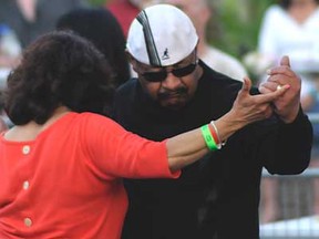 A couple dances during a performance by Alexander Zonjic and Motor City Horns at Carrousel of the Nations at Riverfront Festival Plaza in Windsor, Ont. Saturday, June 8, 2013. (Rob Benneian/Special to The Star)