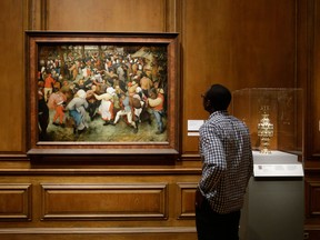 In a June 13, 2013 photo, The Wedding Dance by Pieter Bruegel the Elder is displayed at the Detroit Institute of Arts in Detroit. In a quest to balance the budget in cash-strapped Detroit, the city's emergency manager is proposing a controversial idea: sell the city's art. (AP Photo/Carlos Osorio)