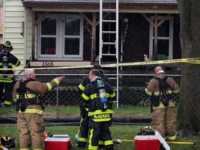 Windsor firefighters extinguish a fire at 1568 Hickory Rd.  where a man escaped by breaking a second-floor window and crawling to the porch roof, Tuesday June 25, 2013. (NICK BRANCACCIO/The Windsor Star)