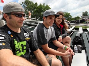 Windsorites Dave, left, Dylan and Liz Muzzatti, sit in the Canadian grandstand while attending the Chevrolet Detroit Belle Isle Grand Prix, Sunday, June 2, 2013.  (DAX MELMER/The Windsor Star)