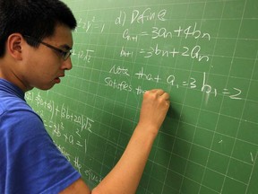 Vincent Massey student Letian Chen works on math problems on the board at Vincent Massey in Windsor on Monday, June 24, 2013. The math students at the school have had great success this year at competitions.                (TYLER BROWNBRIDGE/The Windsor Star)