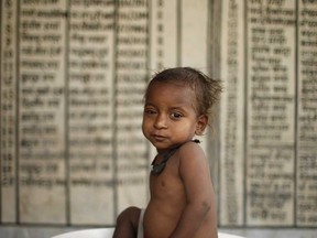 In this handout picture released by UNICEF on June 2, 2009, An Indian child is weighed on a scales at an undisclosed location in the eastern Indian state of Bihar on April 29, 2009. (Handout/AFP/Getty Images)