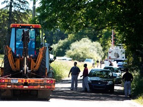 FBI agents direct a vehicle carrying digging machinery to a field to dig for the possible remains of former Teamsters union president Jimmy Hoffa June 17, 2013 in Oakland Township, Michigan. The agents were acting on a tip provided by Tony Zerilli, 85, a former mobster, who was released from prison in 2008. Hoffa, who had reported ties to organized crime, went missing in July of 1975. (Photo by Bill Pugliano/Getty Images)