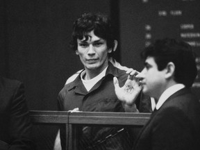 This 1985 file photo shows Richard Ramirez, center, know as the Night Stalker shows a pentagram on the palm of his hand in court. California corrections officials say convicted serial killer Ramirez, known as the Night Stalker, has died in prison. San Quentin State Prison spokesman Lt. Sam Robinson says Ramirez died Friday, June 7, 2013. . The man on the right is unidentified. (AP Photo,File)