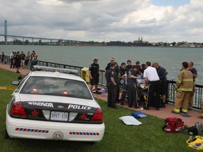 Windsor emergency personnel rescue an adult male from the Detroit River at Riverside Drive and McKay Avenue, Sunday, June 2, 2013.  (DAX MELMER/The Windsor Star)