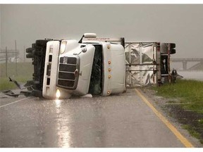 Overturned trucks block a frontage road off I-40 just east of 81 in El Reno, Okla., after a tornado moved through the area on Friday, May 31, 2013. (AP Photo/The Oklahoman, Jim Beckel)