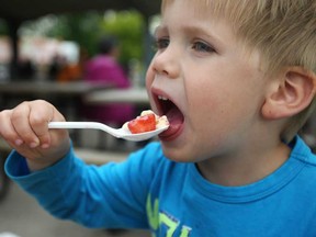 Lucas Lanspeary, 3, enjoys some strawberries and ice cream at the 26th Annual LaSalle Strawberry Festival at Gil Maure Park, Sunday, June 9, 2013.  (DAX MELMER/The Windsor Star)