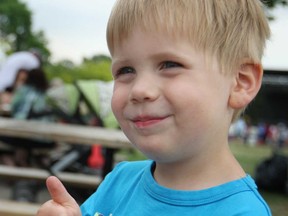 Lucas Lanspeary, 3, gives a thumbs up after tasting some strawberries and ice cream at the 26th Annual LaSalle Strawberry Festival at Gil Maure Park, Sunday, June 9, 2013.  (DAX MELMER/The Windsor Star)