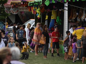 People attend the 26th Annual LaSalle Strawberry Festival at Gil Maure Park try to win prizes from the vendors, Sunday, June 9, 2013.  (DAX MELMER/The Windsor Star)