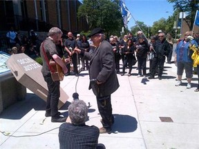 A protester belts out a Windsor version of Guthrie's "This Land is Your Land," referencing Bowlero, shawarma, in protest of the closure of the Social Justice Centre at the University of Windsor on Monday, June 3, 2013. (twitterpic)