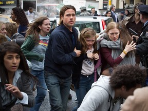 This publicity image released by Paramount Pictures shows, from center left, Brad Pitt as Gerry Lane, Abigail Hargrove as Rachel Lane, and Mireille Enos as Karin Lanein a scene from "World War Z." (AP Photo/Paramount Pictures, Jaap Buitendijk