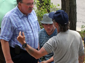 Ward 3 councillor Fulvio Valentinisl, left,  speaks with panhandlers on Ouellette Avenue offering help after receiving complaints from his constituents June 21, 2013.  Panhandler, centre, goes by the street name of Batman. Man, right, is known as Gramps. (NICK BRANCACCIO/The Windsor Star)