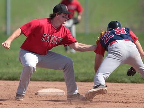 Essex's Justin Orton, left, tags out Holy Names' Rex Romero in Essex. (DAN JANISSE/The Windsor Star)