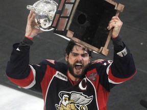 Grand Rapids Griffins captain Jeff Hoggan holds up the Calder Cup after his team defeated the Syracuse Crunch 5-2 in Game 6 of the Calder Cup AHL series at the Oncenter War Memorial Arena in Syracuse, N.Y. (AP Photo/The Syracuse Newspapers, Mike Greenlar)