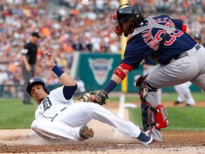 Detroit's Victor Martinez, left, slides past the tag of Boston's Jarrod Saltalamacchia during the second inning at Comerica Park Friday. (Photo by Gregory Shamus/Getty Images)