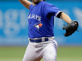 Toronto pitcher R.A. Dickey delivers a pitch to Tampa Bay's Desmond Jennings during the first inning in St. Petersburg, Fla. (AP Photo/Chris O'Meara)