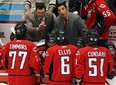 Spitfires assistant coach D.J. Smith, left, Bob Boughner talk to their team during a time out during a playoff game in 2009. (TYLER BROWNBRIDGE/The Windsor Star)