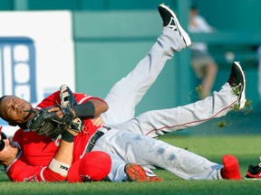 Los Angeles' Erick Aybar, top, and J.B. Shuck tumble to the ground after they collided following Aybar's catch of a fly ball hit by Andy Dirks of the Tigers in the second inning at Comerica Park.