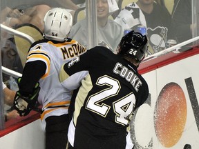 Ex-Spit Matt Cooke, right, checks Boston's Adam McQuaid during Game 1 of the Eastern Conference final Saturday in Pittsburgh. (Photo by Jamie Sabau/Getty Images)