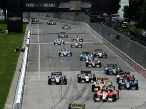 Mike Conway leads drivers into turn one during a restart of the first of two IndyCar Detroit Grand Prix auto races on Belle Isle in Detroit Saturday. (AP Photo/Paul Sancya)