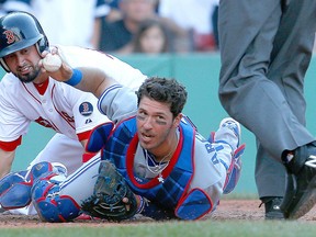 Toronto catcher J.P. Arencibia, right, tags out Shane Victorino of the Red Sox at the plate in the sixth inning at Fenway Park. (Photo by Jim Rogash/Getty Images)