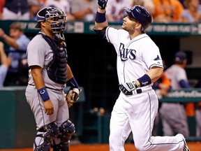 Tampa Bay designated hitter Luke Scott, right, celebrates his homer in the eighth inning against the Detroit Tigers at Tropicana Field Saturday. (Photo by J. Meric/Getty Images)