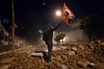 demonstrator waves a Turkish flag with a portrait of Kemal Ataturk between Taksim and Besiktas in Istanbul on June 4, 2013 during a demonstration against the demolition of the park. (ARIS MESSINIS/AFP/Getty Images)