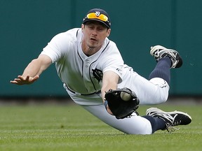 Tigers centre-fielder Don Kelly dives to catch a fly ball by Tampa Bay's James Loney in the fourth inning Thursday in Detroit. (AP Photo/Paul Sancya)