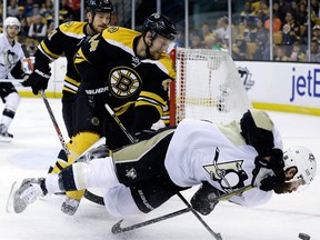 Boston's Dennis Seidenberg, left, checks Pittsburgh's Pascal Dupuis in  Game 4 Friday. (AP Photo/Elise Amendola)