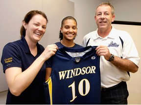 Mike Havey, right, and Chantal Vallee, left, welcome Miah-Marie Langlois to the women's basketball team at the University of Windsor in 2009. (Star file photo)