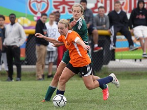 L'Essor's Madeline Weerts, left, battles with Racquel Veenhof of Holy Cross during girls OFSAA soccer in Tecumseh Friday. (TYLER BROWNBRIDGE/The Windsor Star)