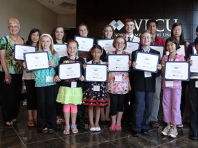 Marty Komsa (left), Clara Hewitt (second from left) and Marty Gillis (right) are photographed with the scholarships winners during a presentation ceremony for the 2013 Harold Hewitt Scholarships at the WFCU offices in Windsor on Monday, June 3, 2013. Sixteen scholarships were handed out.            (TYLER BROWNBRIDGE/The Windsor Star)