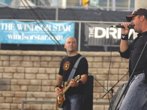 Drop Dead Famous lead singer Rob Higgins (right) and lead guitarist Dave Sinewitz (left) perform at Beaverfest '13 at the Riverfront Amphitheatre Saturday, June 1. (Photo by/Rob Benneian)