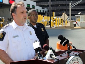 Paul Susko, acting director of Border Operations with the CBSA and Chief Ken Hammond, spokesman for U.S. Customs and Border Protection, hold a media conference outside the duty free store on the Detroit side of the tunnel. They offered tips for crossing the border during the busy summer travel season. (TREVOR WILHELM/The Windsor Star)