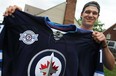 Austen Brassard, 20, holds up a Winnipeg Jets jersey outside his Windsor home Sunday, June 2, 2013. Brassard signed an $1.86-million contract with the Jets. (DAX MELMER/The Windsor Star)
