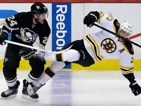 Former Spitfire Matt Cooke, left, collides with Boston's Chris Kelly during Game 2 of the NHL Eastern Conference final in Pittsburgh Monday, June 3, 2013. (AP Photo/Gene J. Puskar)