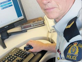 RCMP Cpl. Richard De Jong with the ask.fm website open on a computer in North Vancouver Thursday. 'It's really user beware,' De Jong said of this and similar websites.
(Gerry Kahrmann/Postmedia News)
