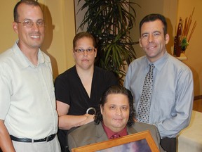 Robert Vinson, centre, holds a portrait of his late parents Erma and Rev. Adam Vinson, surrounded by, James Vinson, from left, Michelle Vinson and Brian Friday, June 21, 2013, at Victoria Greenlawn Funeral Home. Erma Vinson fostered more than 250 children over 60 years, was a founding member of Price Memorial AME Church and helped build a school in Ghana, Africa. Vinson died Wednesday, June 18, 2013 at the age of 89. Julie Kotsis/The Windsor Star