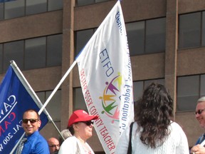 Windsor-Essex public school teachers carry flags during a local protest on June 11, 2013. (Dan Janisse / The Windsor Star)